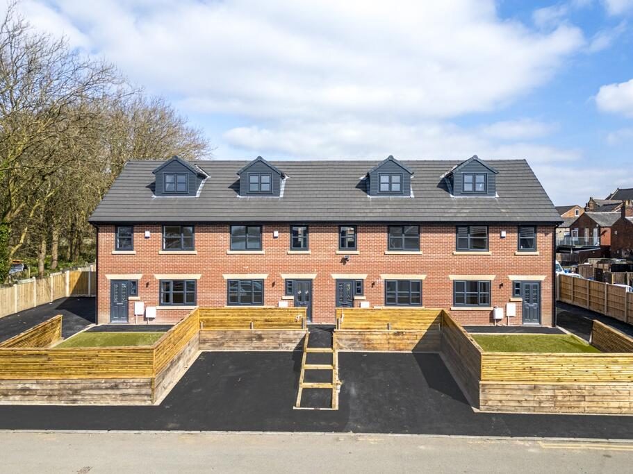 Completed terrace of nine three-storey townhouses at King Street, Hindley